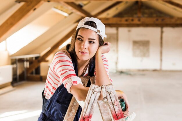 Young woman renovating her new home, holding paint roller