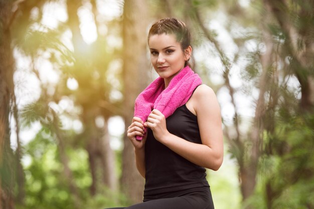 Young Woman Resting After Running In Wooded Forest Area  Training And Exercising For Trail Run Marathon Endurance  Fitness Healthy Lifestyle Concept