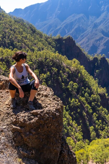 A young woman resting after trekking on top of La Cumbrecita