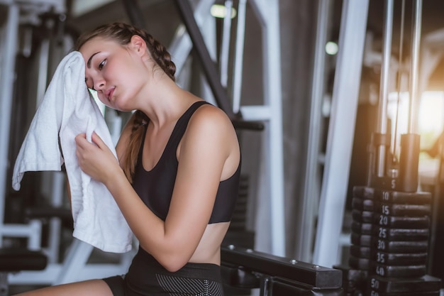 Young woman resting at gym