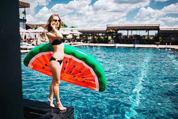 Young woman resting at swimming pool