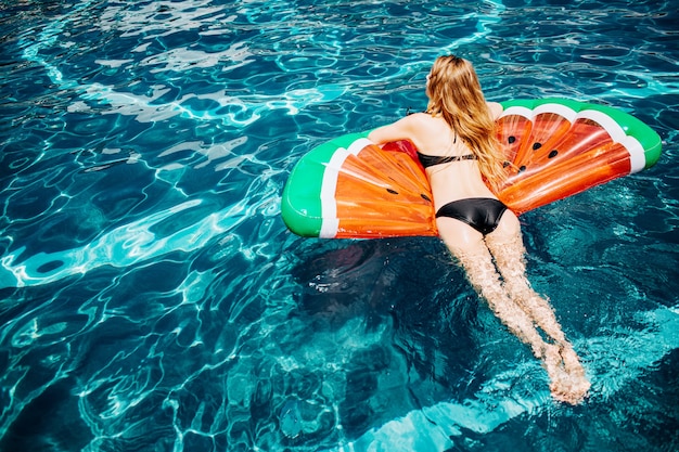 Young woman resting at swimming pool