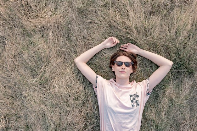 Young woman rests on the grass enjoying the spring.