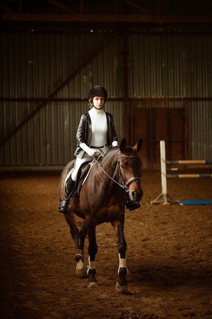 Young woman rider on dressage horse an abstract shot of horse during competition cute girl jockey si...