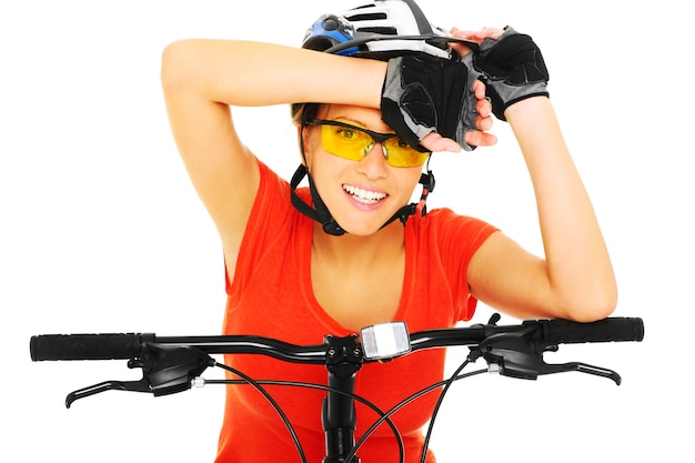 young woman riding bike over white background