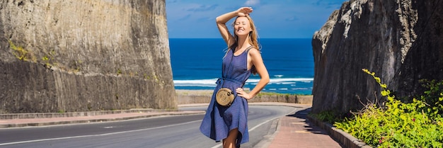 Photo young woman on road to the beach pandawa nusa dua bali indonesia banner long format