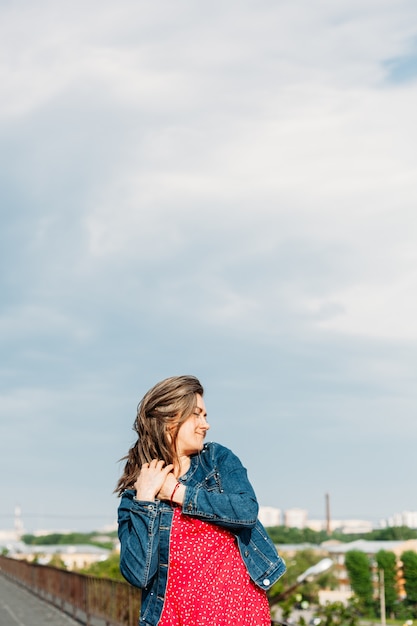 Young woman on the roof of the house