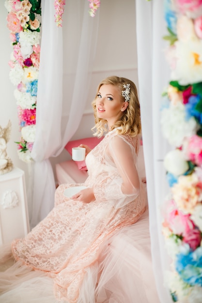 Young woman in the room decorated with flowers