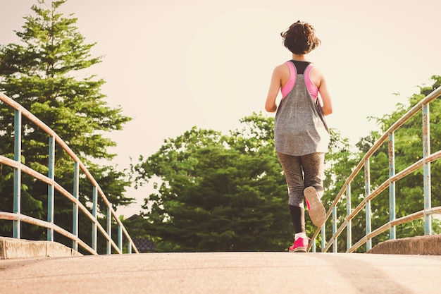 young woman runner of running at park