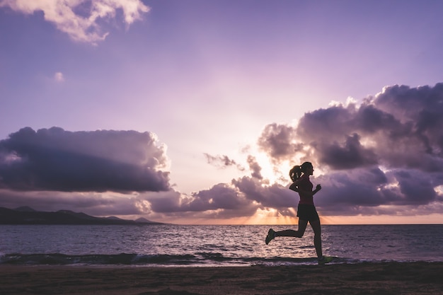 Young woman running on the beach