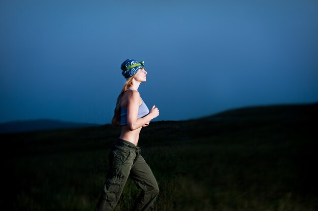 Young Woman Running In The Dark With Headlamp