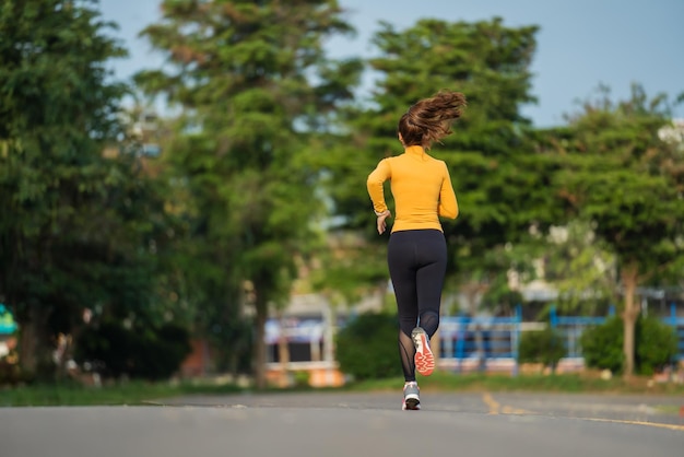 Young woman running in the park in early morning