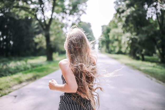 young woman runs away on the road the concept of women's freedom equality and female success