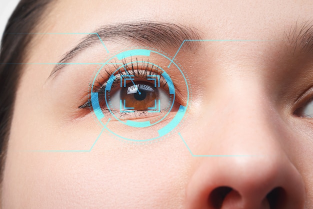 The young woman 's eye is close-up. The concept of the new technology is iris recognition.