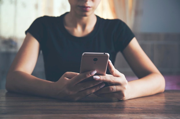 Young woman's hands holding smart phone