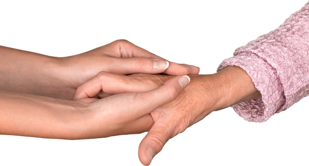 Young Woman's Hands Touching and Holding an Old Woman's Hand