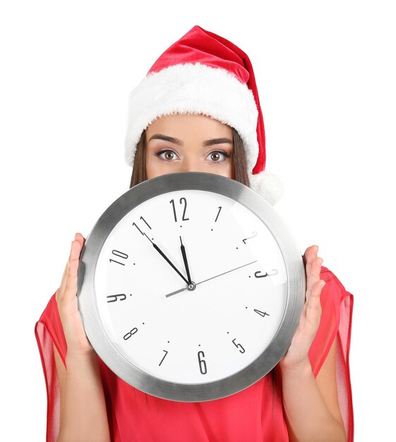 Young woman in santa hat with clock on white background. christmas countdown concept