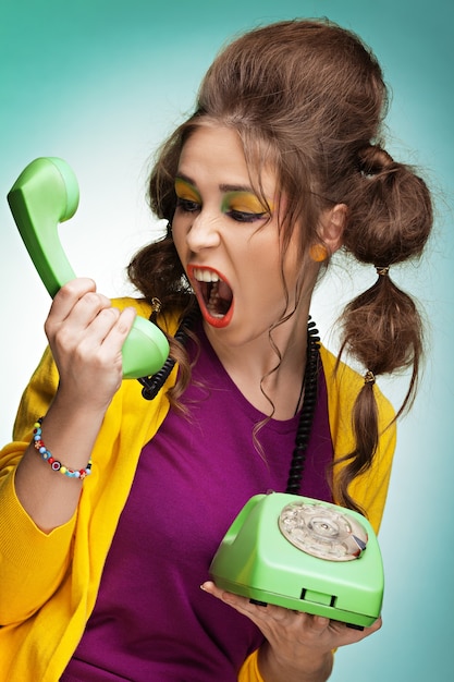 Young woman screaming on the phone