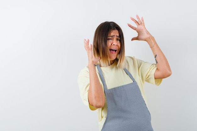 Young woman screaming on white background