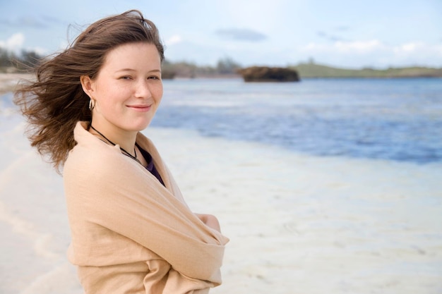 Young woman at the sea smiling optimistically