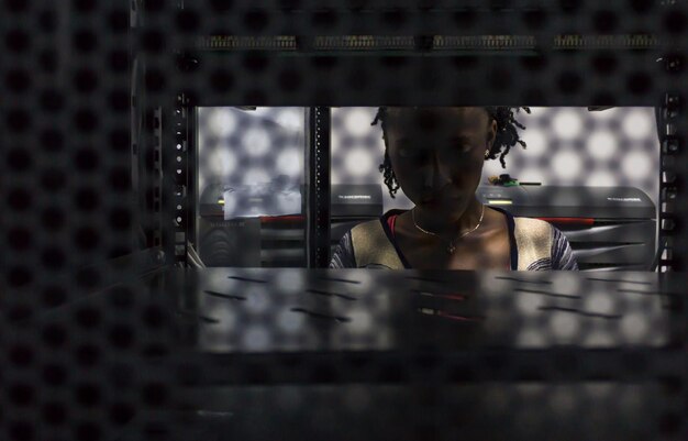 Young woman seen through shelf