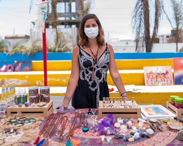 Young woman selling handicrafts at fair.