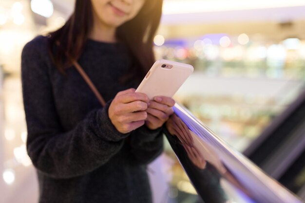 Young Woman sending text message in mobile phone