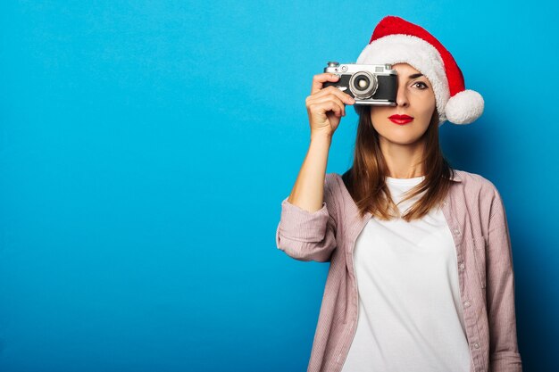 Young woman in a shirt wearing a Santa Claus hat