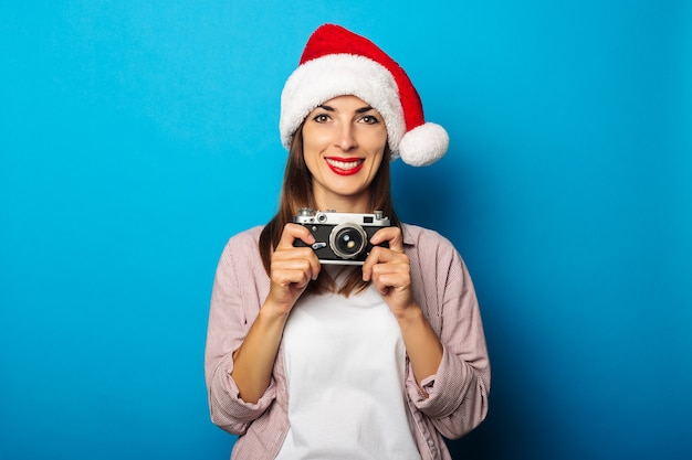 Young woman in a shirt wearing a Santa Claus hat