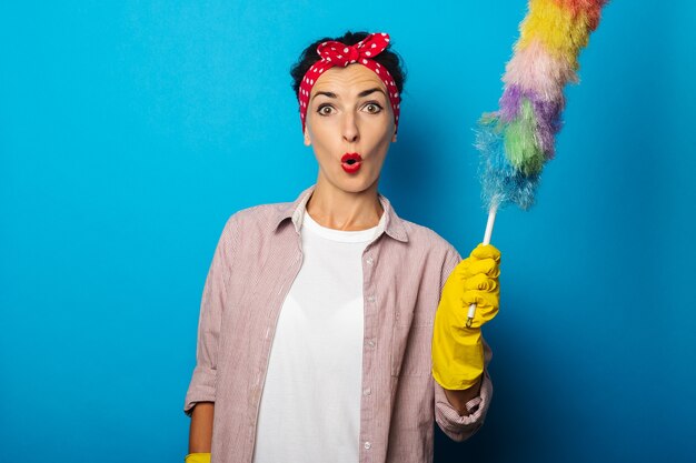 Young woman in shirt with cleaning gloves