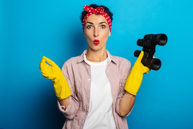 Young woman in shirt with cleaning gloves