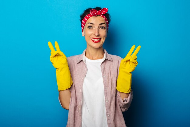 Young woman in shirt with cleaning gloves