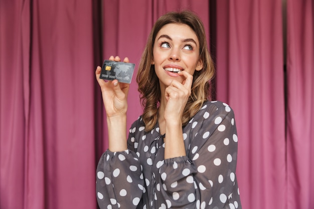 Young woman shopaholic standing near changing room