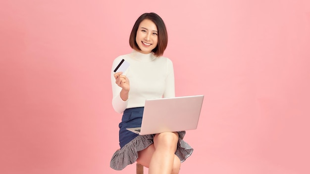 Young woman shopping online and paying with credit card