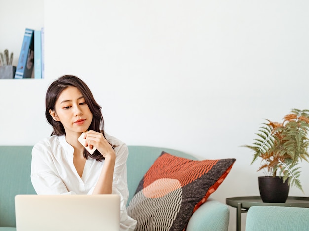 Young woman shopping online with credit card and laptop at home