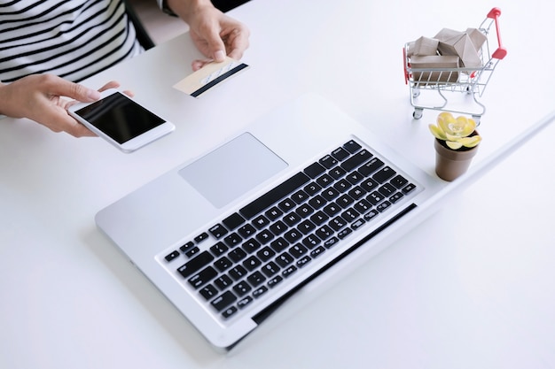 Photo young woman shopping online with debit / credit card, payment and marketing concept