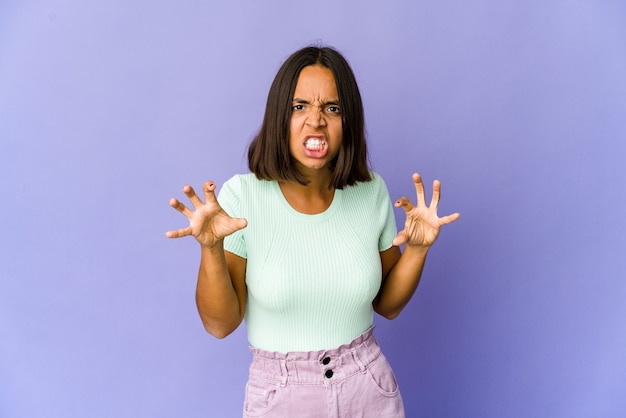 Young woman showing claws imitating a cat