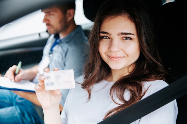 Young woman showing driver licence