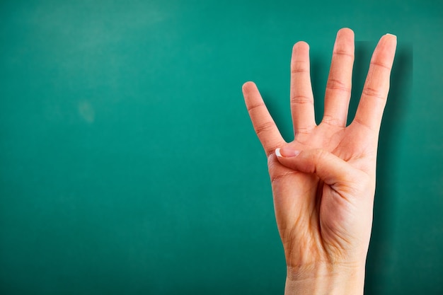 Young woman showing four fingers with hand