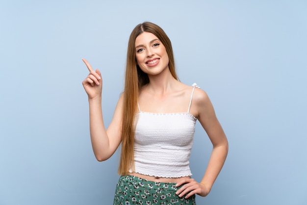 Young woman showing and lifting a finger in sign of the best