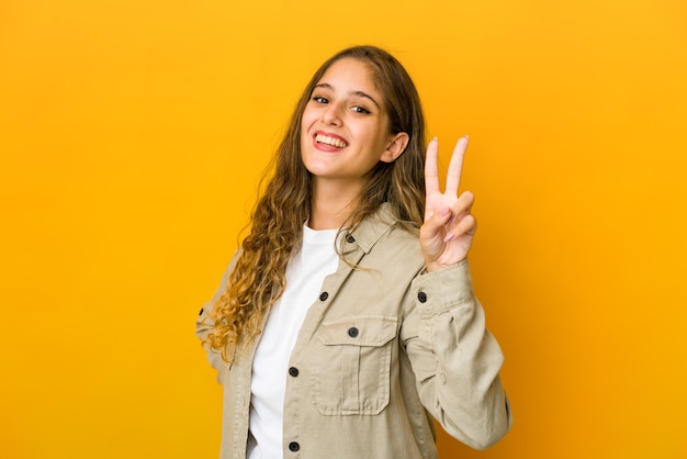 Young woman showing number two with fingers