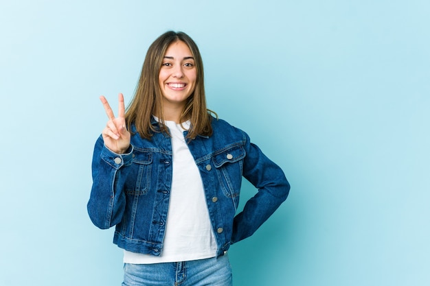 Young woman showing number two with fingers