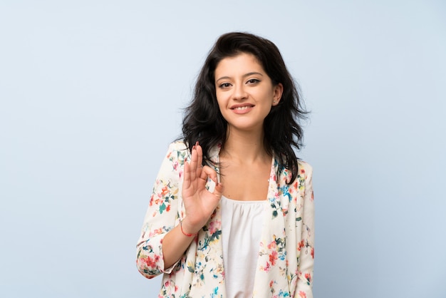 Young woman showing an ok sign with fingers