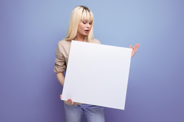 Young woman showing paper sheet with blank space for notes