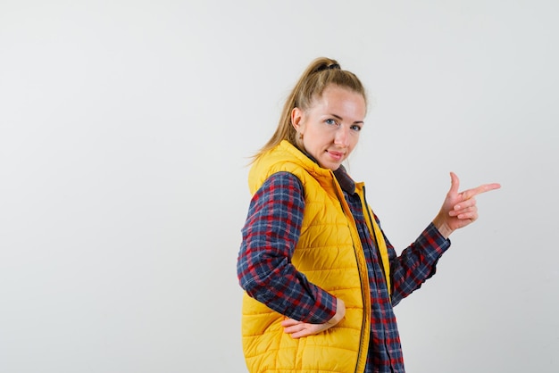 Young woman showing the right with her finger on white background