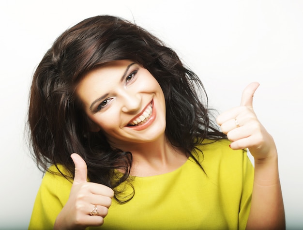 Young woman showing thumbs up gesture