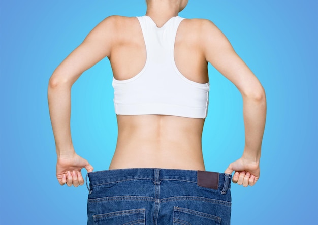 Photo young woman showing waist. weight loss concept