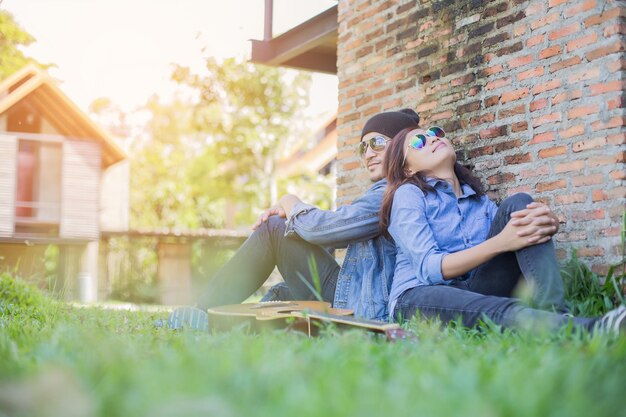 Photo young woman sitting against wall