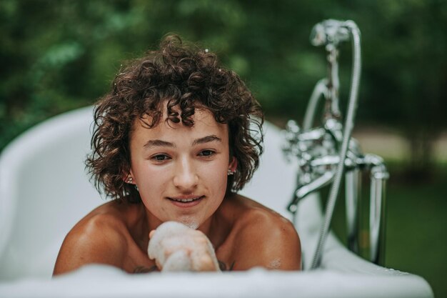 Young woman sitting in bathtub outdoors