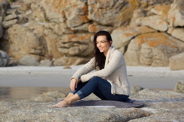 Young woman sitting at the beach